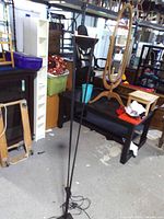 Full view of tall black halogen floor lamp