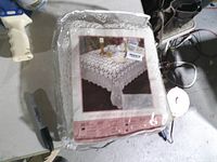 Front of packaged tablecloth showing product photo and label