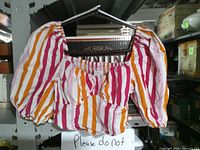 Front view of striped crop top on hanger