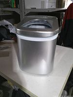 Front and side view of silver countertop ice maker
