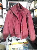 Front view of burgundy padded jacket hanging