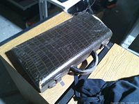 Closed brown faux reptile case on table