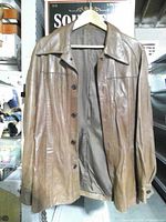 Front view showing overall style, buttons, collar, leather condition