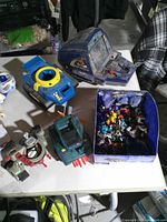 Top view showing all toy vehicles, accessory and box of small figures on table