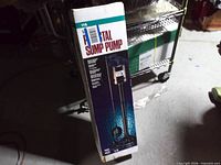 Front of sealed Water Ace pedestal sump pump box showing product image and branding