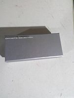 Closed silver Porsche Design Driver's Selection box