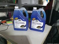 Front view of two Zep All-in-1 Premium Pressure Washing jugs on table