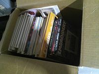 Overview of box showing assorted craft books, titles Creative and Embroidery visible