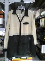 Front view of the sheer color-block blouse on hanger