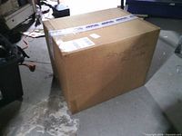 Large sealed cardboard box labeled Shoe Covers XL 1000pc