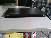 Front angled view showing Sony logo and front-loading slot