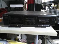 Front view showing missing left cassette door, control buttons, LED meters, overall wear