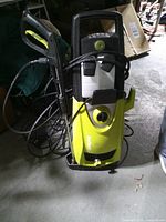 Front view of Sun Joe SPX3000 pressure washer showing body, spray gun, hose, detergent tanks