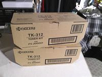 Front view of two stacked Kyocera TK-312 toner kit boxes