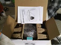 Open box showing manual, molded pulp inserts and wrapped cleaner