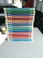 Stacked view of volumes 1-16 showing numbered, colour-coded spines