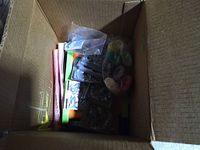 Opened shipping box showing molds, colored pieces and accessories from the workshop set