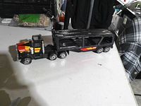 Side view of Buddy L car carrier showing cab and trailer