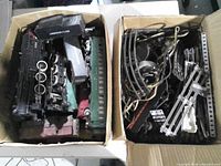 Overview of two boxes with locomotive, cars and track