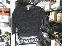 Front view of black lace Xhilaration top hanging