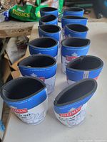 Twelve blue and white Sleeman Clear 2.0 koozies arranged upright