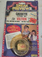 Front of sealed Sneak Previews Voltron cassette blister card