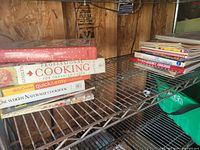 Wide view of both stacks of cookbooks on wire shelf