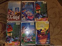 Back covers of six Disney VHS tapes