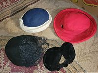 Group shot of all four hats on rug