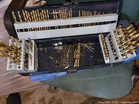 Open case showing full drill bit array on indexed holders