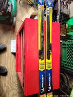 Two Michelin Guardian wiper blades in unopened packaging placed on red surface