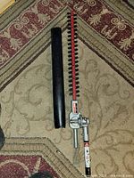 Full view of hedge trimmer attachment and blade guard