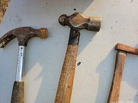 Close-up of claw hammer, ball-peen hammer and small hammer