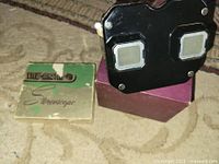Front of black Bakelite View-Master viewer alongside small green/cream Stereoscope box