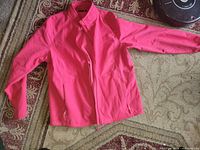 Full view of pink jacket front showing zip closure, collar and pockets