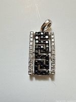 Front view of pendant showing diamond layout and overall design