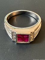 Ring top view showing square ruby cluster and diamond accents