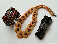 All three jewelry pieces: necklace, multicolour bangle, black bracelet