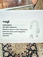 Product label showing Vogt Dornbirn model KF.16D1.0204.CC and feature list