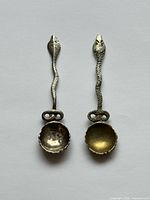 Front view of both sterling snake-handle spoons
