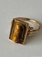 Side view of ring showing tiger eye intaglio and scroll shoulders
