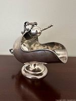 Right side view of sugar scuttle with shovel in holder