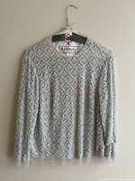 Front view of sequined blouse on hanger