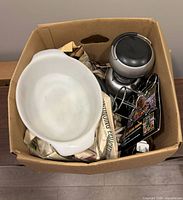 Top view into box showing Corning Ware casserole dish, electric appliance and beaters