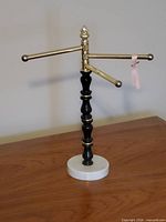 front view showing brass swivel arms, wood column, marble base