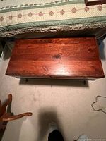 Top view of wooden blanket box showing plank lid and stain finish