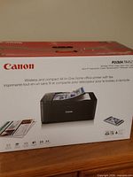 Front of Canon PIXMA TR4527 box showing printer image and wireless fax features
