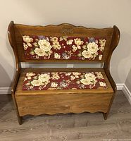 angled view showing bench design, upholstery pattern, wood finish