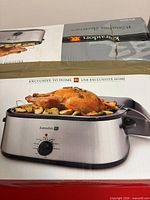 Retail box showing Kuraidori electric roast pan with stainless body and control dial