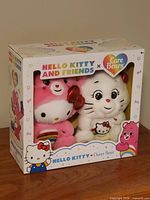 Front view of sealed box showing both plushies and branding